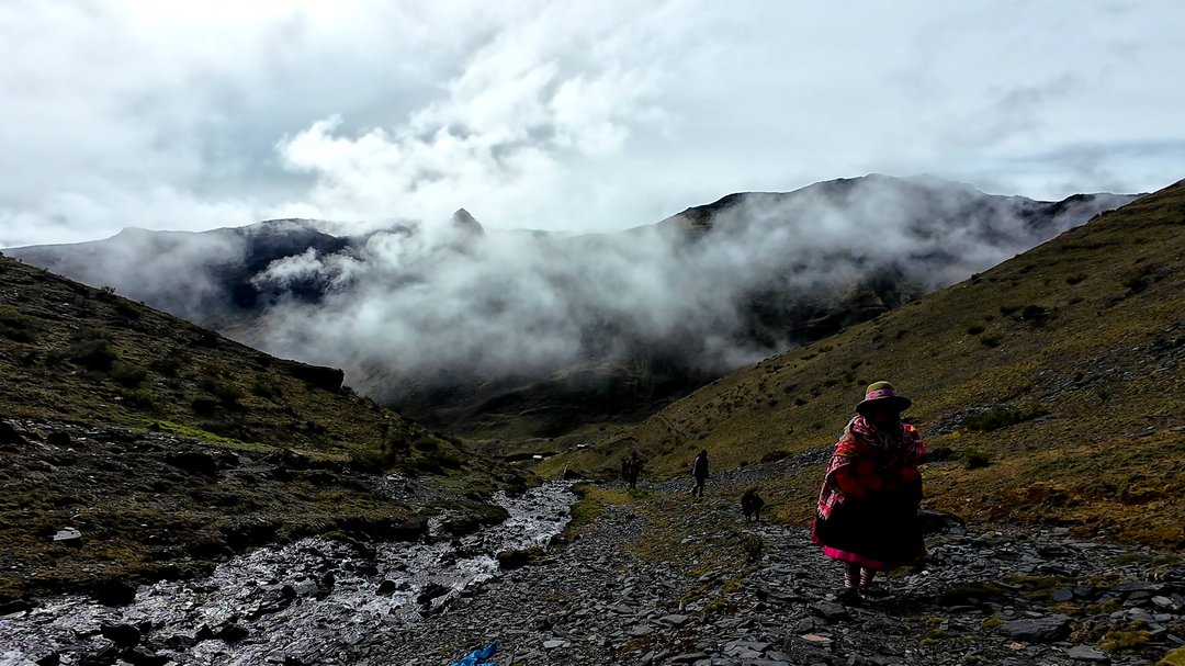 A person meditating peacefully in a natural, serene environment