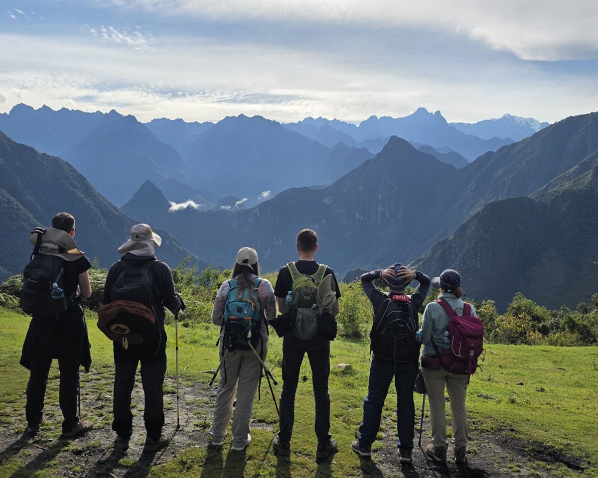 People looking out over a wide mountain horizon