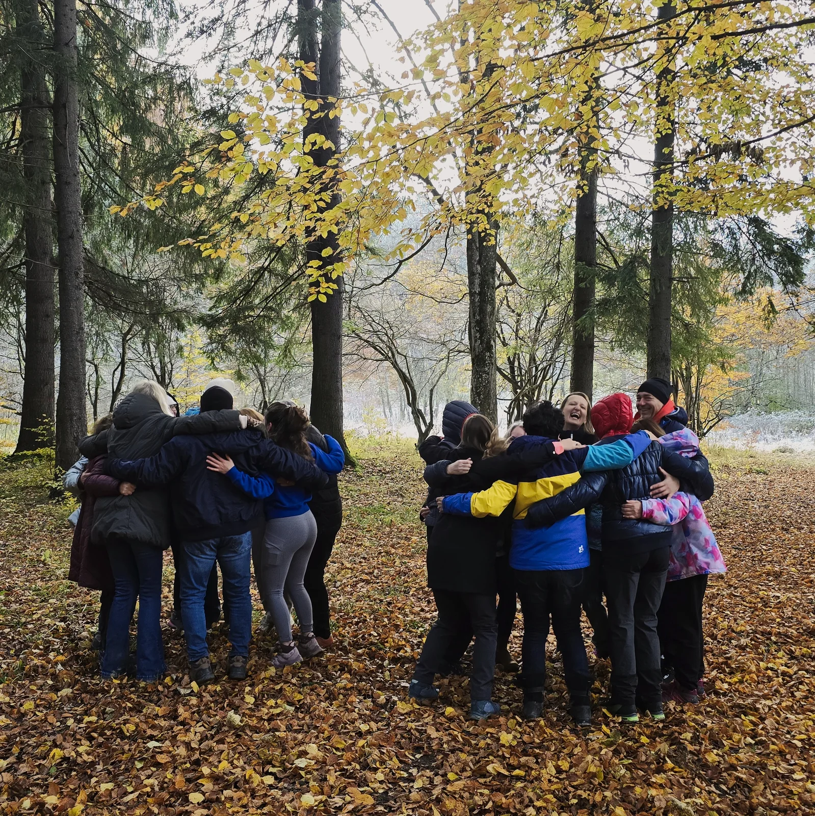A real Inner Spark retreat group embracing in autumn