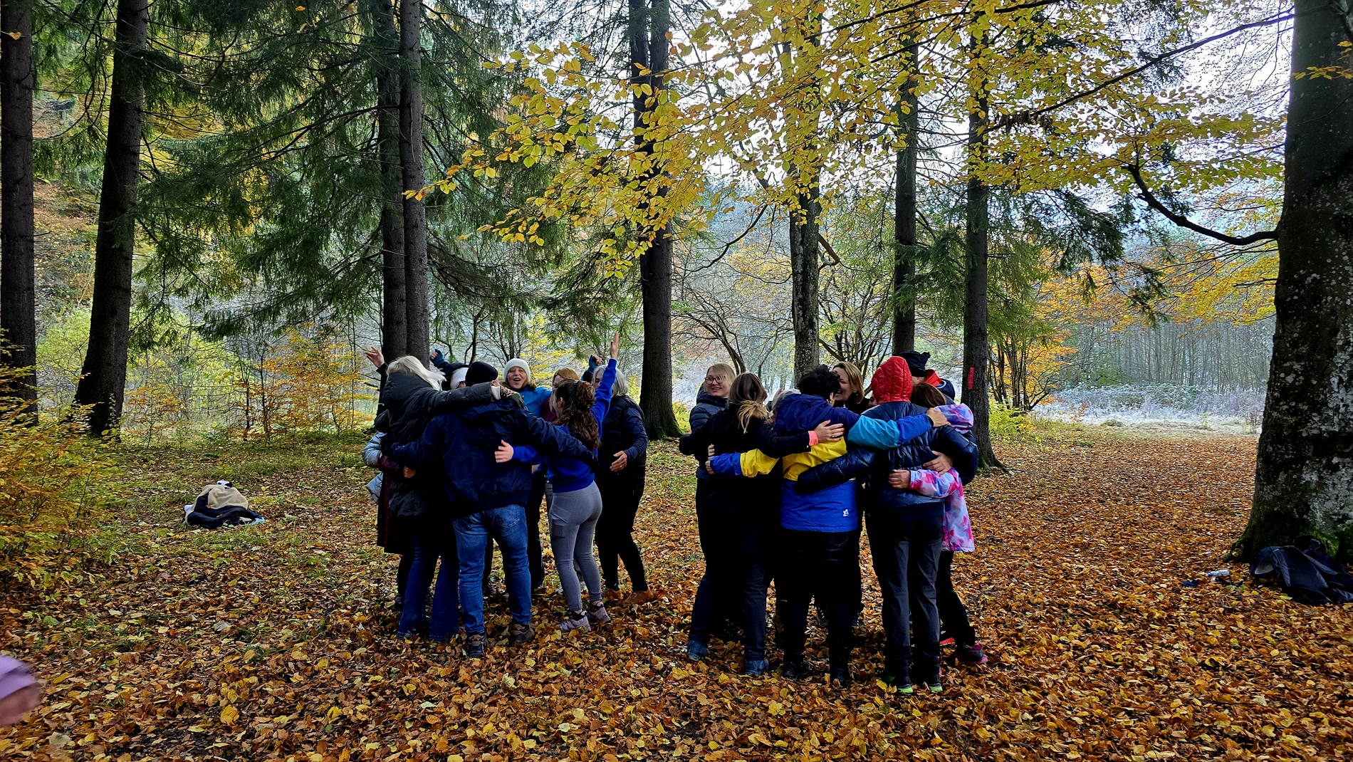 A group embrace in the autumn forest
